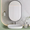 Armoire à miroir ovale noire avec cadre métal, meuble mural avec étagères réglables, rangement salle de bain