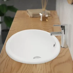 Lavabo en céramique blanc avec garniture de vidage et trop-plein
